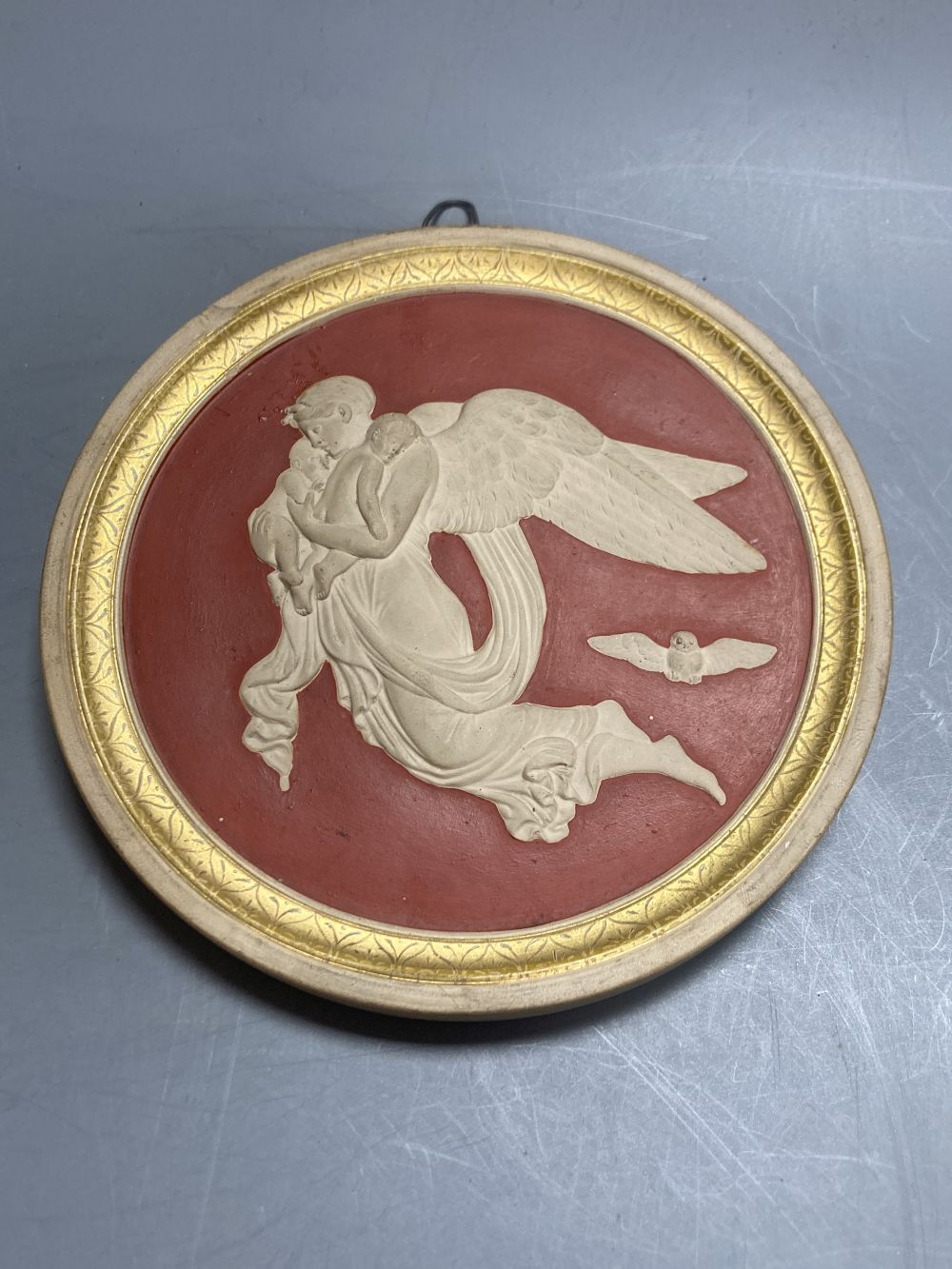 A pair of P. Ipsen Kjobenhavn Eneret relief moulded roundels, depicting night and day, 13cm